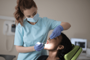 Dentist checking a patient for Gum Disease and performing tooth extraction