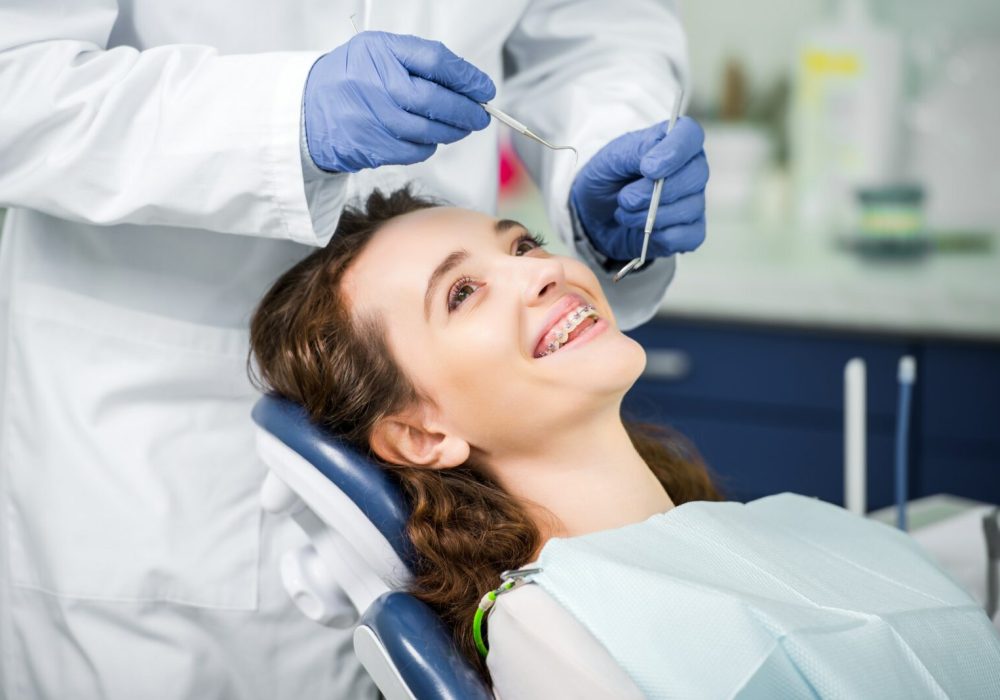 Dentist examining a patients teeth to fit Dental Sealants in beech cottage dental practice gosforth