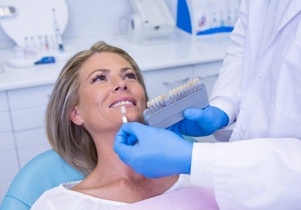 A dentist using Tooth whitening equipment with a patient